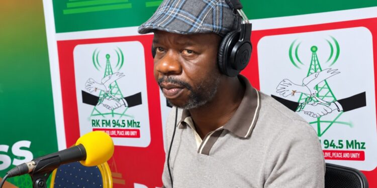 Garrison Doldeh Yeanue speaks to reporters about political tolerance and employment in Nimba County