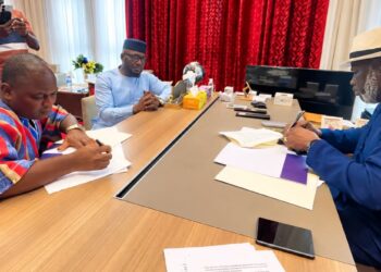 House Speaker Richard Nagbe Koon and CoSPAL Secretary-General Dapo Oyewole sign the Host Country Agreement