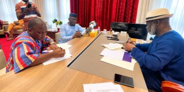 House Speaker Richard Nagbe Koon and CoSPAL Secretary-General Dapo Oyewole sign the Host Country Agreement