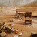 Students at J.F. Clarke Elementary School sit on damaged chairs and cement blocks during class