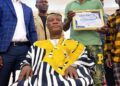 An elder presents Sen. Samuel Kogar with a traditional rod during a ceremony in Nimba County