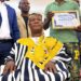 An elder presents Sen. Samuel Kogar with a traditional rod during a ceremony in Nimba County