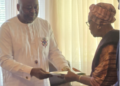 Ambassador Al-Hassan Conteh presents Rev. J. Edwin Lloyd Sr.’s posthumous award to his widow, Emma Mitchell Lloyd