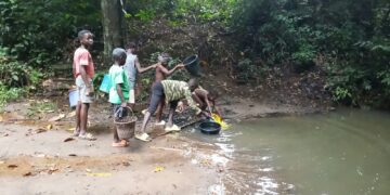 Gbarney residents near a community water source in Bong County