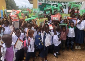 Nursery pupils receiving school supplies from the Fissebu Youth Development Association in Lofa County.