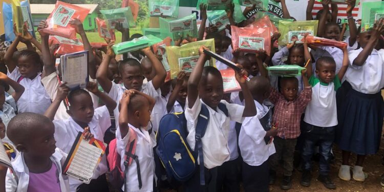 Nursery pupils receiving school supplies from the Fissebu Youth Development Association in Lofa County.