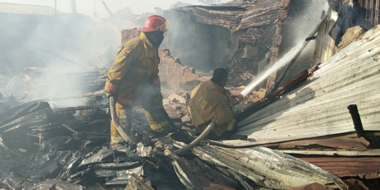 Firefighters at the scene of a fire on Jamaica Road, Bushrod Island.