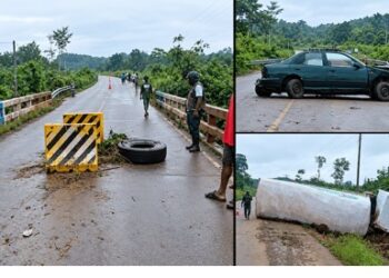 A damaged green sedan lying across the roadway at Janapita Bridge in Bong County.