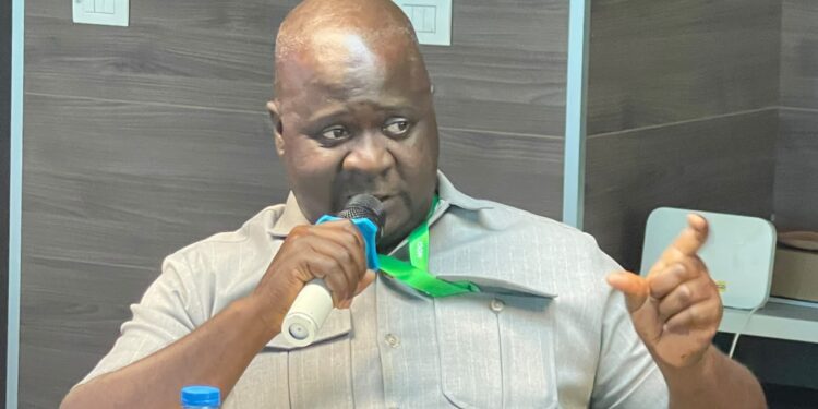 Acting Commerce Minister Stephen M. Yekeson Jr. announcing market pricing measures in Monrovia.