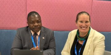 NaFAA Director General J. Cyrus Saygbe Sr., left, and World Bank official Valerie Hickey.
