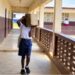 Student carrying concrete block to a classroom at J.W.A. Richards School in Louisiana Township, Liberia.